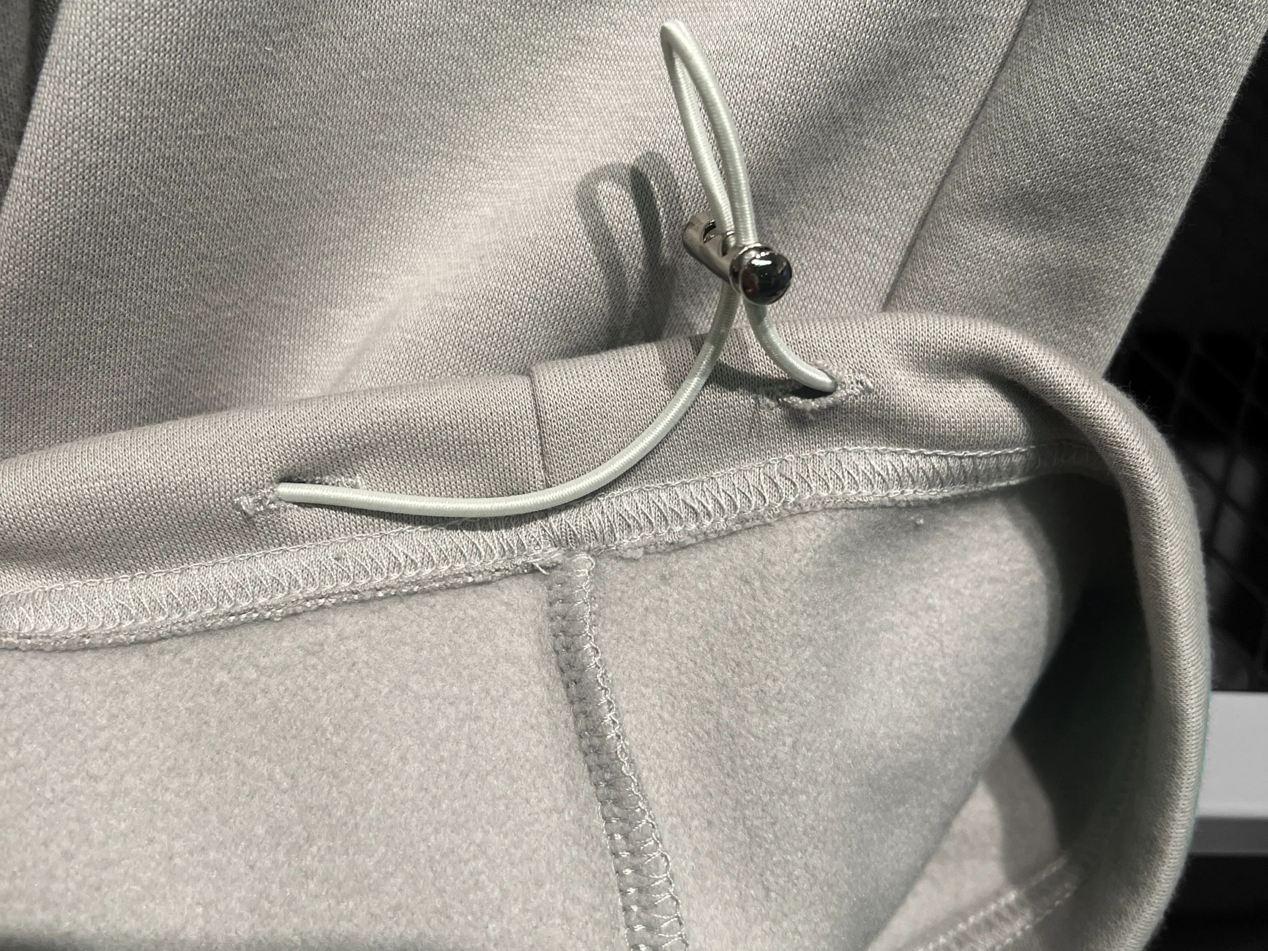 Rib cuff binding and hem finishing reviewed before sportswear bulk production