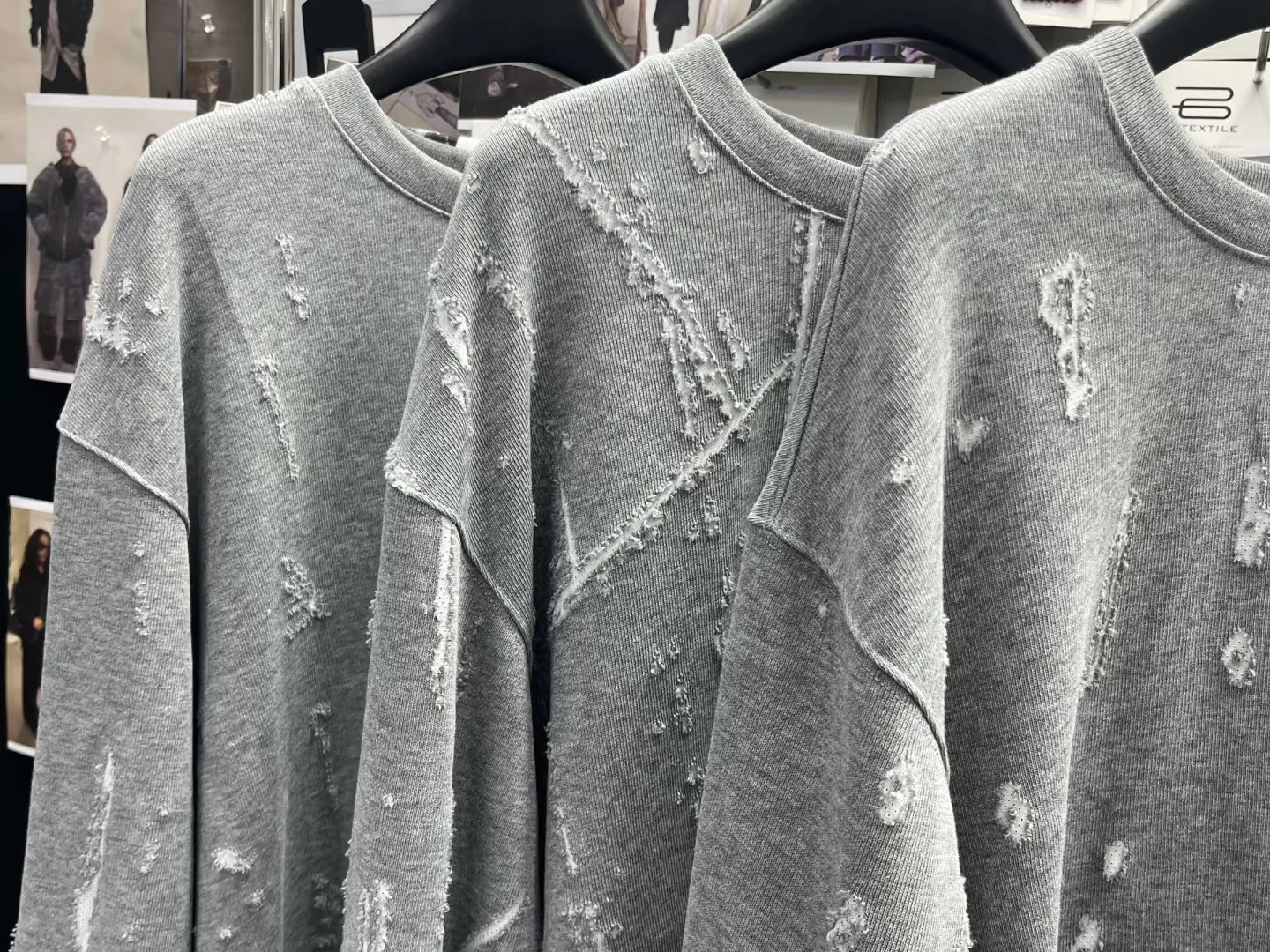 Controlled distressing abrasion and worn surface effects on cut-and-sew knit garments